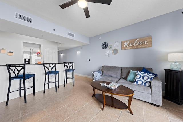 living room with light tile patterned flooring and ceiling fan