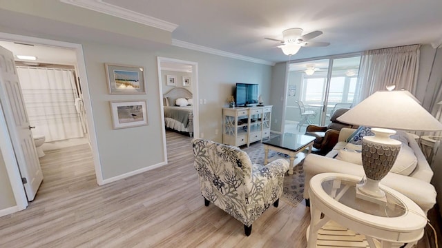 living room featuring light hardwood / wood-style flooring, ceiling fan, and crown molding