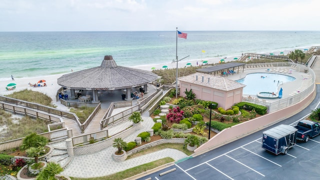 birds eye view of property with a view of the beach and a water view