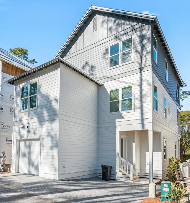 rear view of property featuring a garage