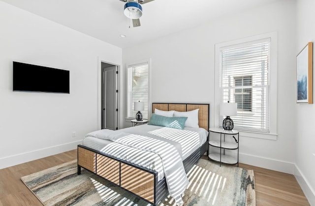 bedroom with ceiling fan and light wood-type flooring