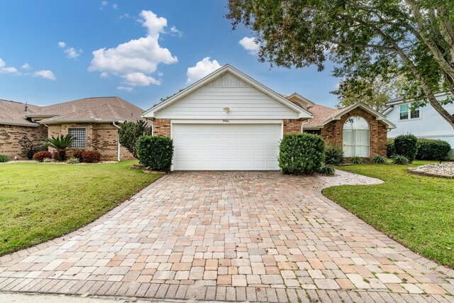 946 Shalimar Point Dr, Shalimar, FL 32579 - ranch-style house with decorative driveway, brick siding, a garage, and a front yard