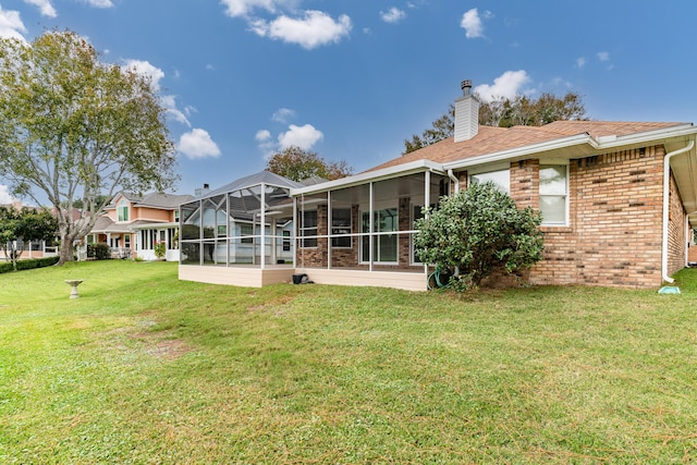 946 Shalimar Point Dr, Shalimar, FL 32579 - back of property featuring a sunroom, a lawn, a chimney, and brick siding