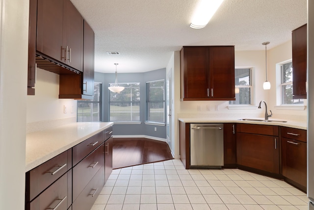 946 Shalimar Point Dr, Shalimar, FL 32579 - kitchen featuring stainless steel dishwasher, a sink, light countertops, healthy amount of natural light, and a textured ceiling