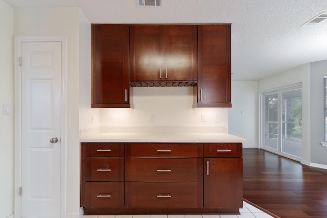 946 Shalimar Point Dr, Shalimar, FL 32579 - kitchen with light countertops, dark wood-type flooring, baseboards, and a textured ceiling