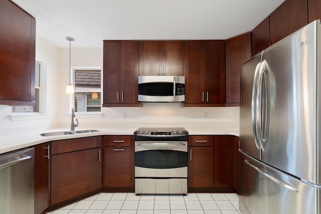 946 Shalimar Point Dr, Shalimar, FL 32579 - kitchen featuring appliances with stainless steel finishes, a sink, light countertops, a textured ceiling, and light tile patterned flooring