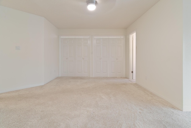 946 Shalimar Point Dr, Shalimar, FL 32579 - unfurnished bedroom featuring multiple closets, light carpet, and baseboards