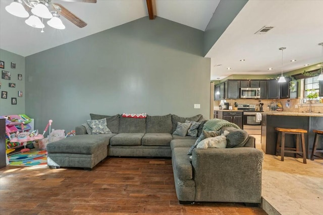 living room featuring ceiling fan, lofted ceiling with beams, dark hardwood / wood-style flooring, and sink