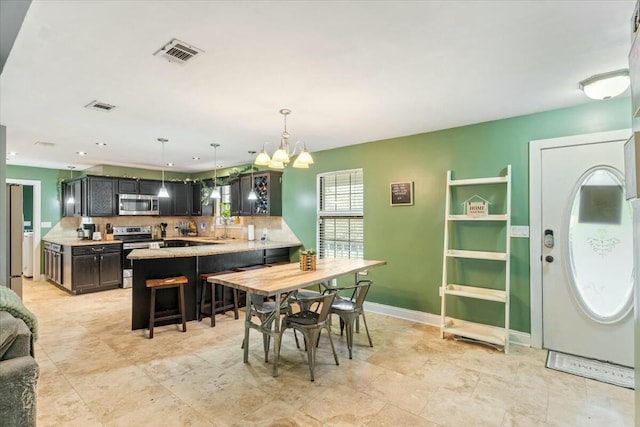 dining area featuring a notable chandelier and sink