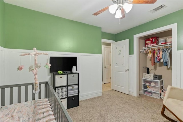 carpeted bedroom featuring a closet and ceiling fan