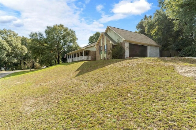 view of home's exterior featuring a garage and a yard