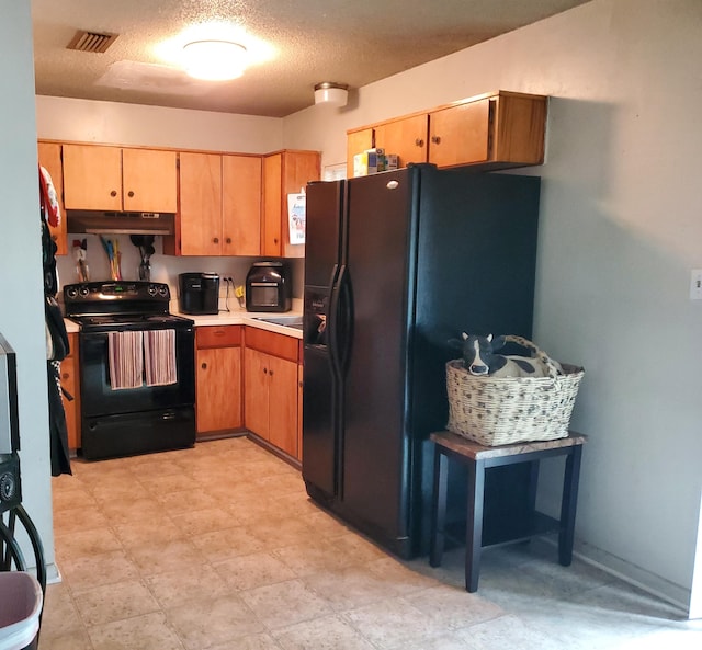 50 Junior Dr, Shalimar, FL 32579 - kitchen featuring black appliances, light countertops, under cabinet range hood, and a textured ceiling