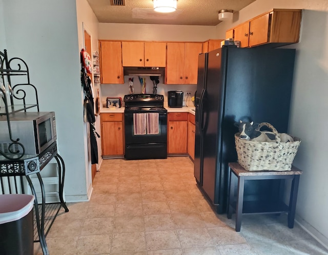 50 Junior Dr, Shalimar, FL 32579 - kitchen with black appliances, under cabinet range hood, light countertops, and baseboards