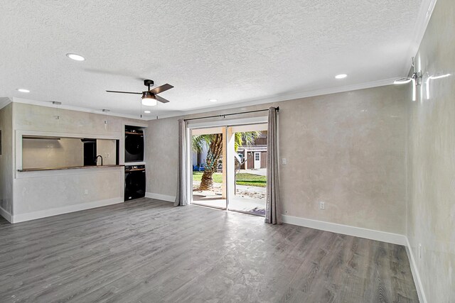 402 Marshall Ct Unit 01, Fort Walton Beach, FL 32548 - unfurnished living room with a textured ceiling, baseboards, ceiling fan, wood finished floors, and recessed lighting