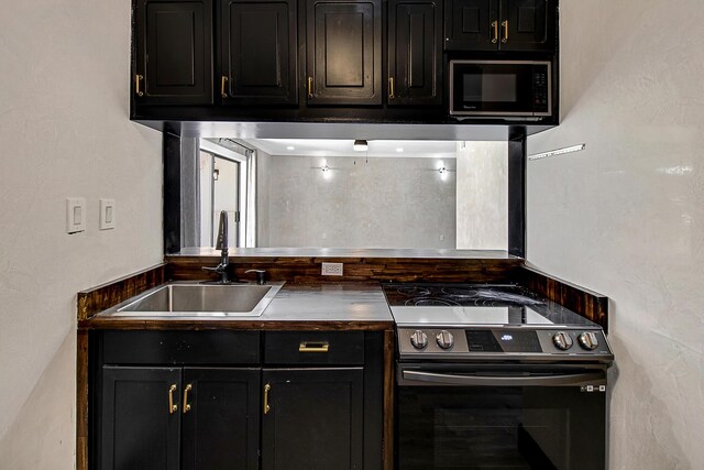 402 Marshall Ct Unit 01, Fort Walton Beach, FL 32548 - kitchen with stainless steel electric range, a sink, dark countertops, and dark cabinetry