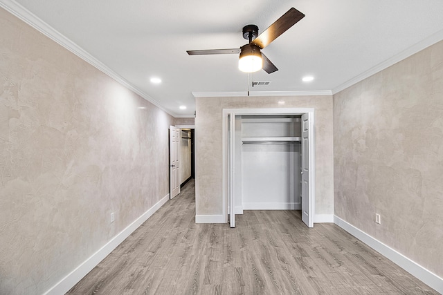 unfurnished bedroom featuring ceiling fan, a closet, ornamental molding, and light wood-type flooring