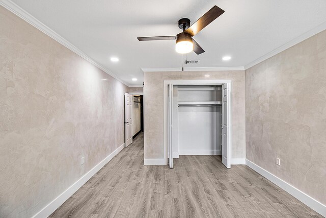402 Marshall Ct Unit 01, Fort Walton Beach, FL 32548 - unfurnished bedroom with wood finished floors, crown molding, baseboards, a closet, and ceiling fan