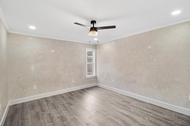 empty room with ceiling fan, ornamental molding, and hardwood / wood-style flooring