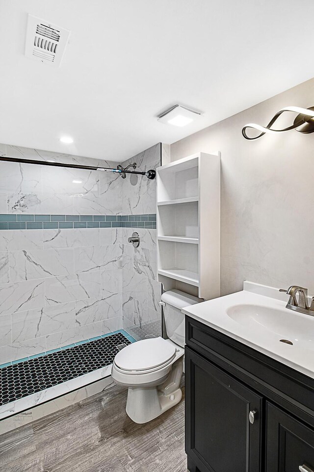 402 Marshall Ct Unit 01, Fort Walton Beach, FL 32548 - full bathroom with vanity, a shower stall, toilet, and wood finished floors