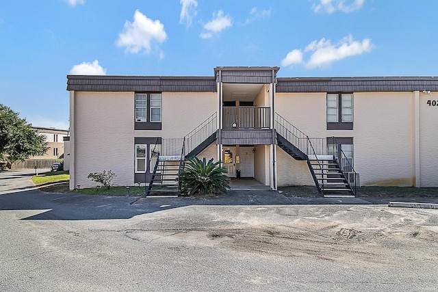402 Marshall Ct Unit 01, Fort Walton Beach, FL 32548 - view of building exterior with stairs and uncovered parking