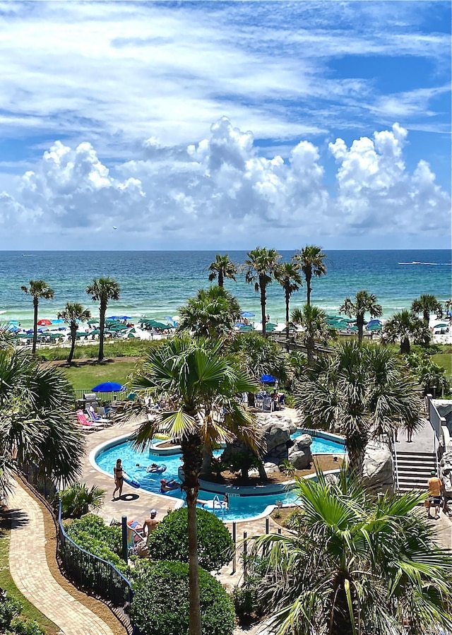 community pool featuring a water view and a patio