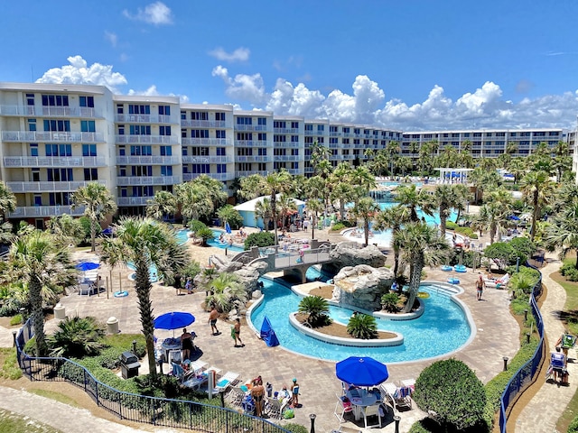 drone / aerial view of a pool area and apartment complex