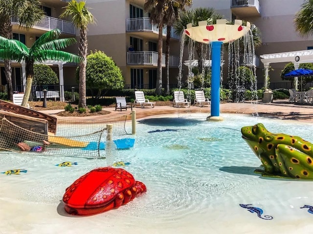 community pool featuring a patio and fence