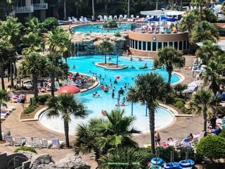 view of swimming pool with a patio area and a jacuzzi