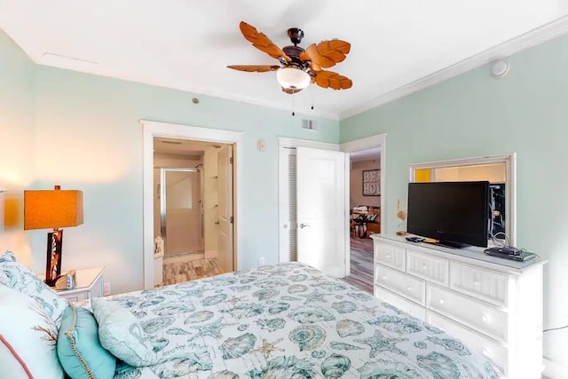 bedroom with wood finished floors, ornamental molding, and a ceiling fan