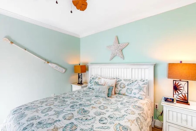 bedroom with ceiling fan and crown molding