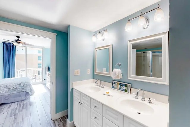 full bath featuring ensuite bath, ceiling fan, double vanity, and an enclosed shower