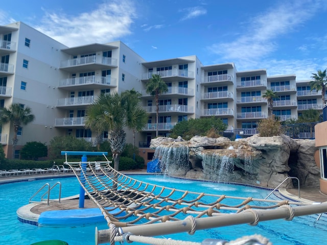 view of swimming pool featuring pool water feature