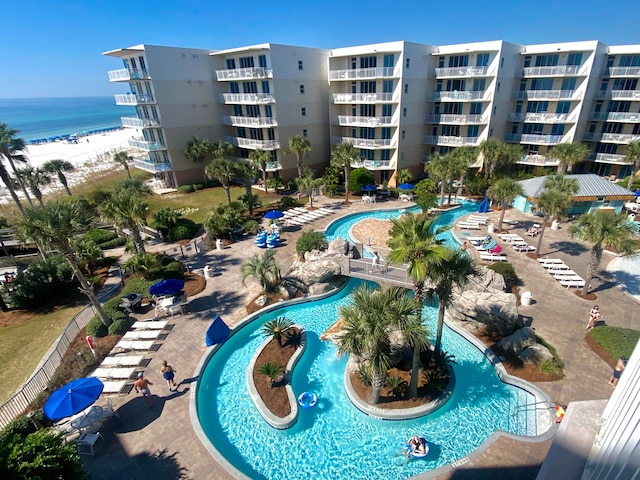 view of swimming pool with a patio and a water view