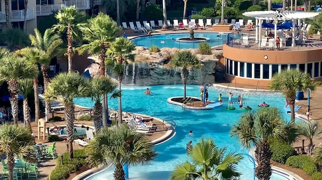 view of pool with a hot tub and pool water feature