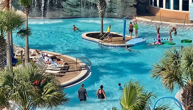 view of swimming pool featuring pool water feature