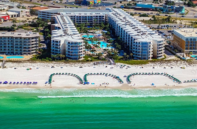 birds eye view of property with a beach view and a water view