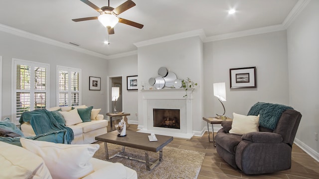 living room featuring ceiling fan, hardwood / wood-style floors, and ornamental molding