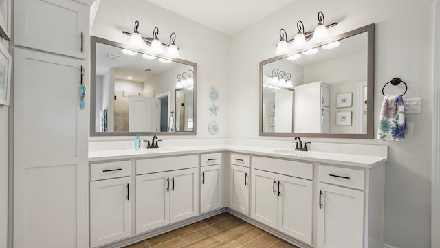 bathroom with vanity, wood-type flooring, and walk in shower