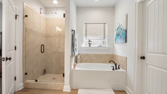 bathroom featuring separate shower and tub