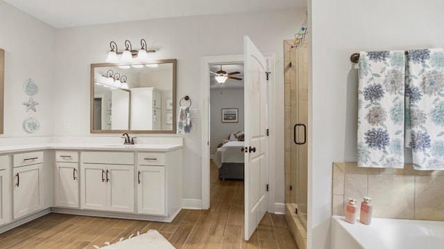 bathroom with vanity, hardwood / wood-style flooring, separate shower and tub, and ceiling fan