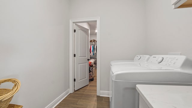 washroom featuring washer and clothes dryer and dark wood-type flooring