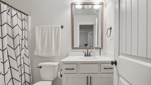 bathroom featuring vanity, toilet, and curtained shower