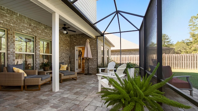 sunroom featuring a wealth of natural light and ceiling fan