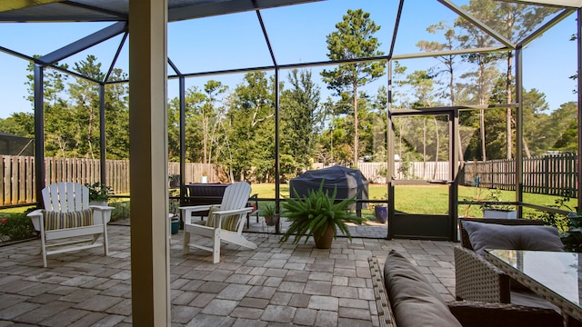 view of patio / terrace with glass enclosure and grilling area