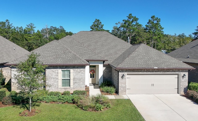 view of front of home with a front yard and a garage