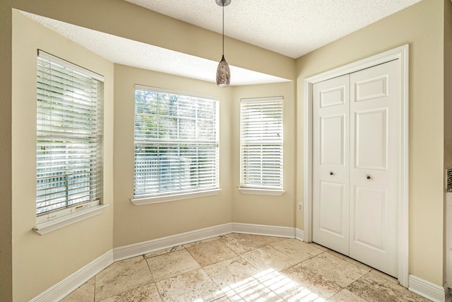 interior space with a textured ceiling