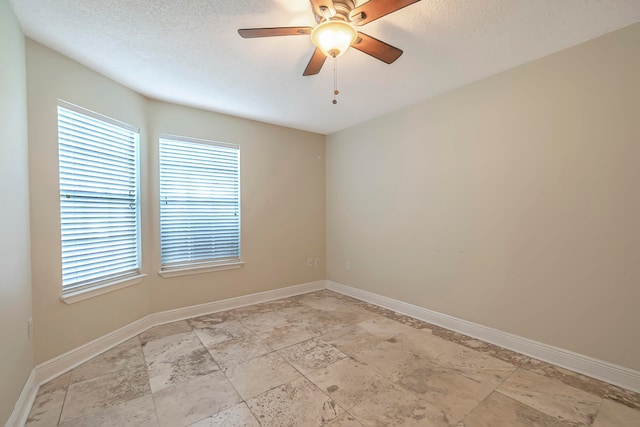 spare room featuring ceiling fan and a textured ceiling