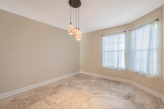 unfurnished room featuring a textured ceiling