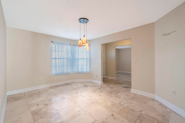 unfurnished dining area featuring a chandelier