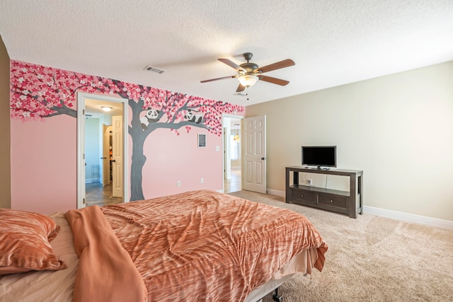 carpeted bedroom with a textured ceiling and ceiling fan